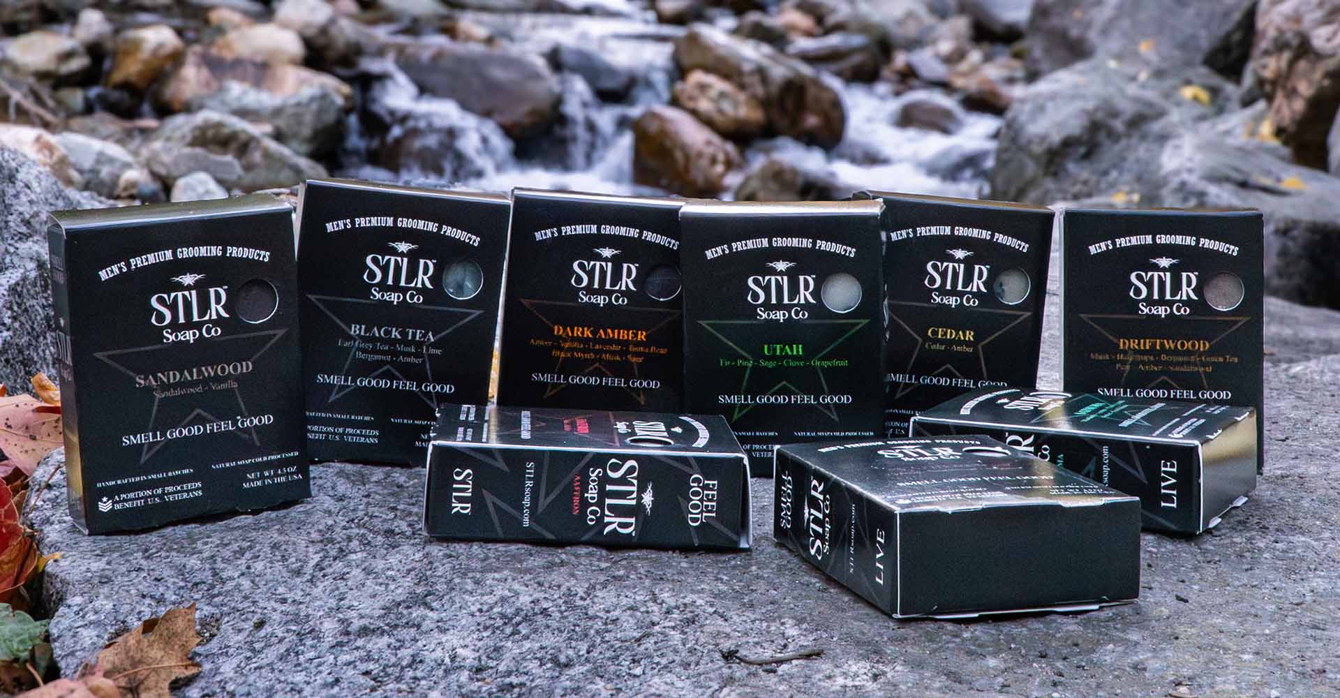 collection of soap bars on a rock in front of a flowing river