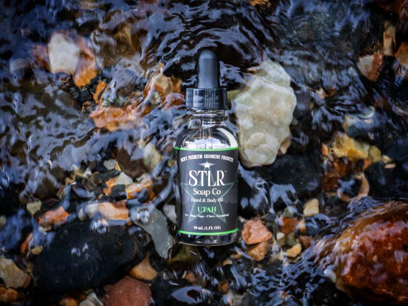beard and body oil in nature setting