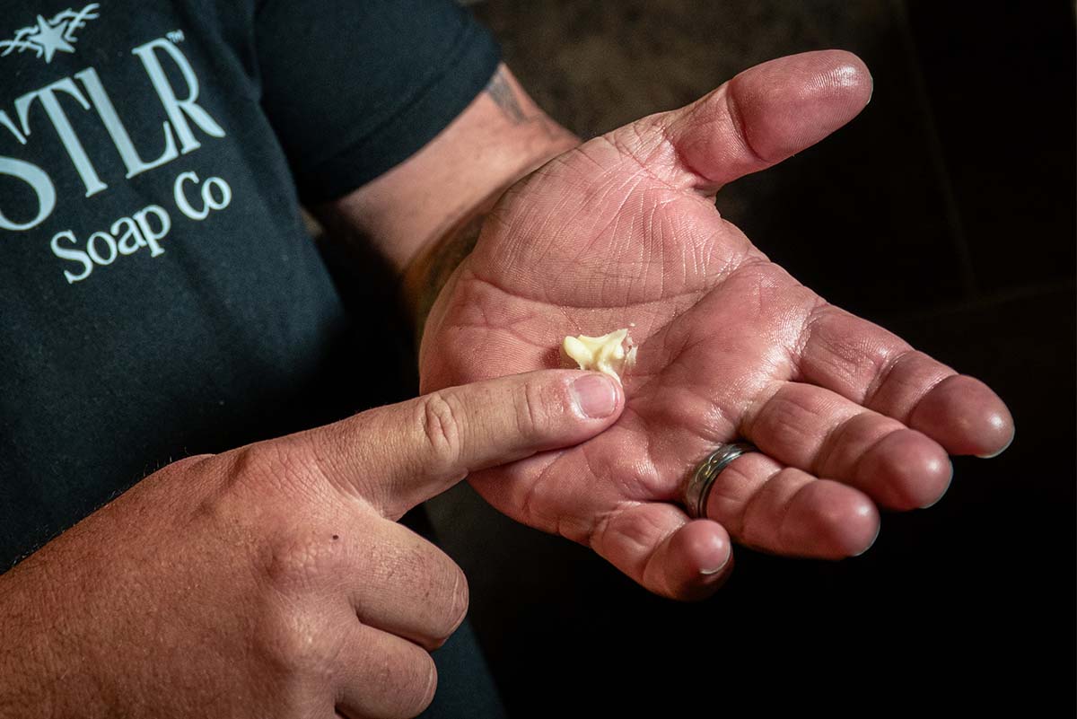 beard butter being applied onto the palm of a man's hand