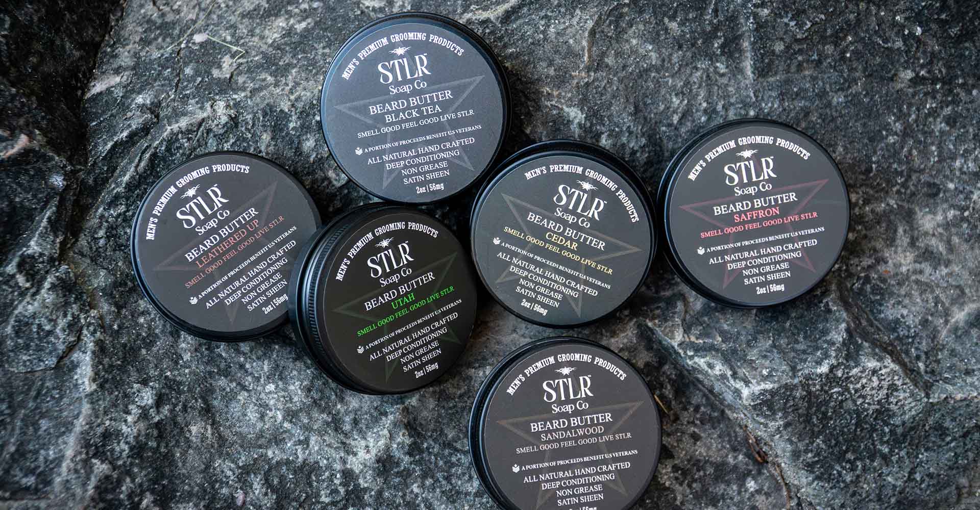 Collection of beard butters on a rock texture