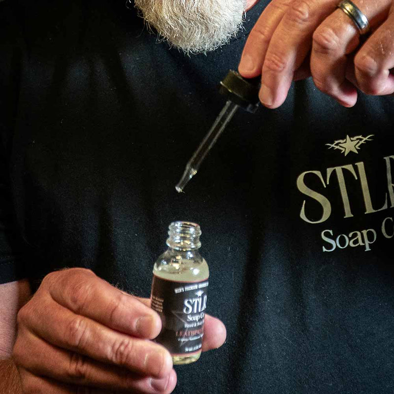 beard oil dropper being pulled from its bottle