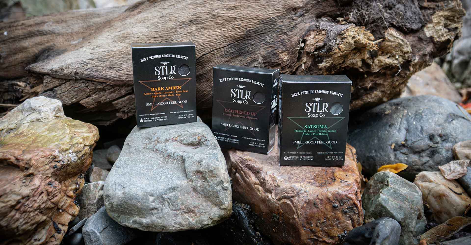 packaged soap products in natural environment with rocks and wood